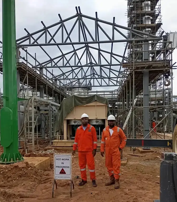 Ralonick workers fully kitted in complete protective gear standing in front of a steel structure